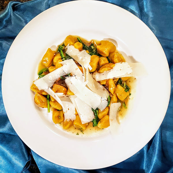 Squash Gnocchi with Caramelized Onions and Arugula